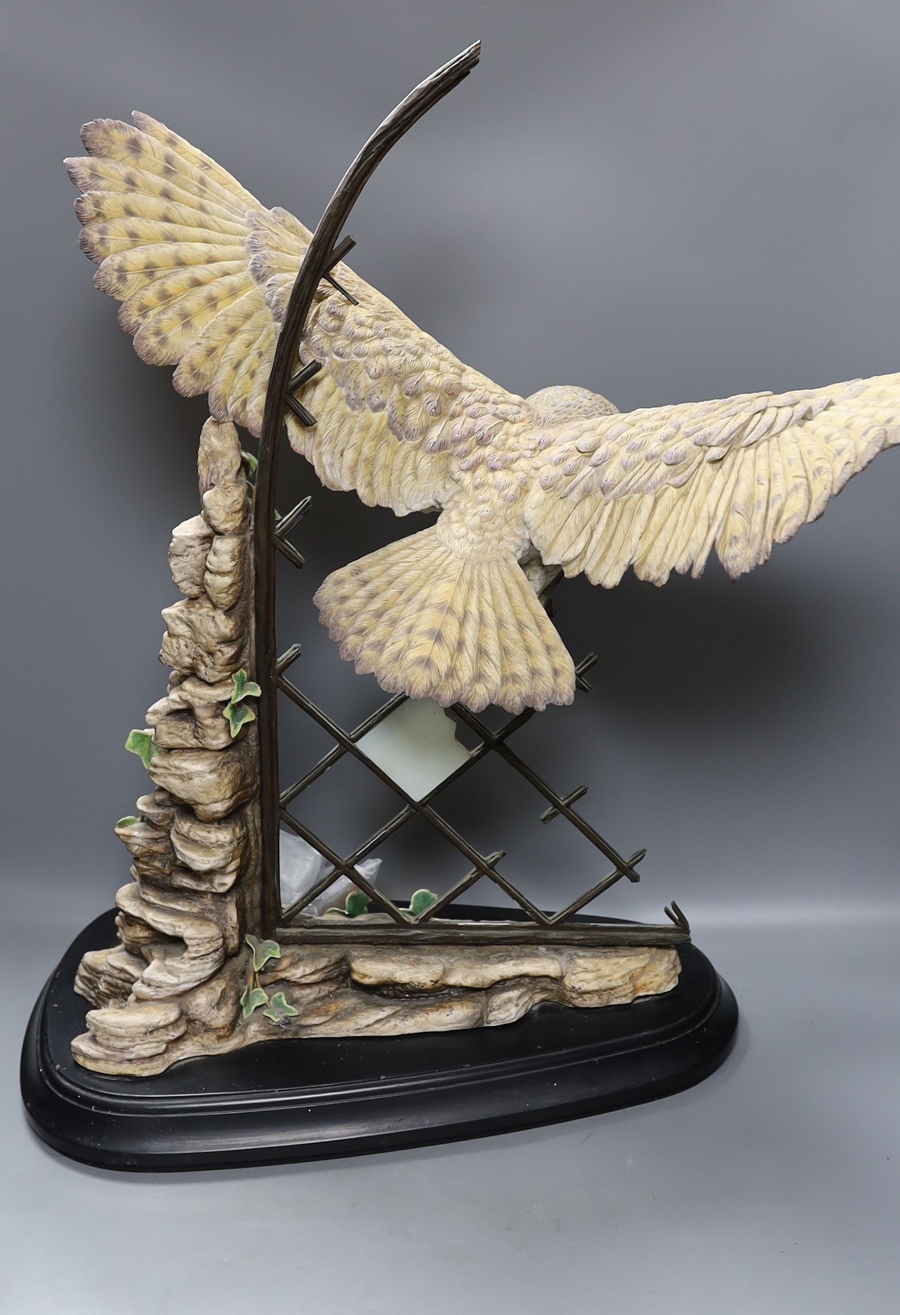 A large ceramic barn owl, on stand, 64 cms high.